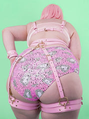 Female model wearing our Candy Pink Zoe Leg Harness with gold hardware.